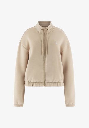 Beżowa bluza zip-up z dopasowaną talią, wysokim kołnierzem i prążkowanymi detalami przy dekolcie i mankietach. Posiada mały graficzny akcent na klatce piersiowej.