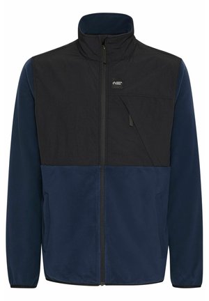 Sötétkék és fekete fleece dzseki, magas gallérral, cipzáras záródással és elülső zsebbel, amelynek ferde fedőlapja van. Puha tapintású.