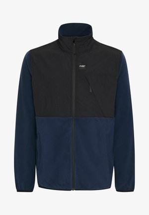 Sötétkék és fekete fleece dzseki, magas gallérral, cipzáras záródással és elülső zsebbel, amelynek ferde fedőlapja van. Puha tapintású.