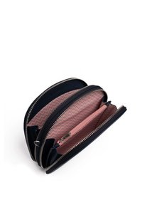 Navy leather wallet with multiple zip compartments, pink chevron-patterned lining, and silver hardware for secure closure and organization.
