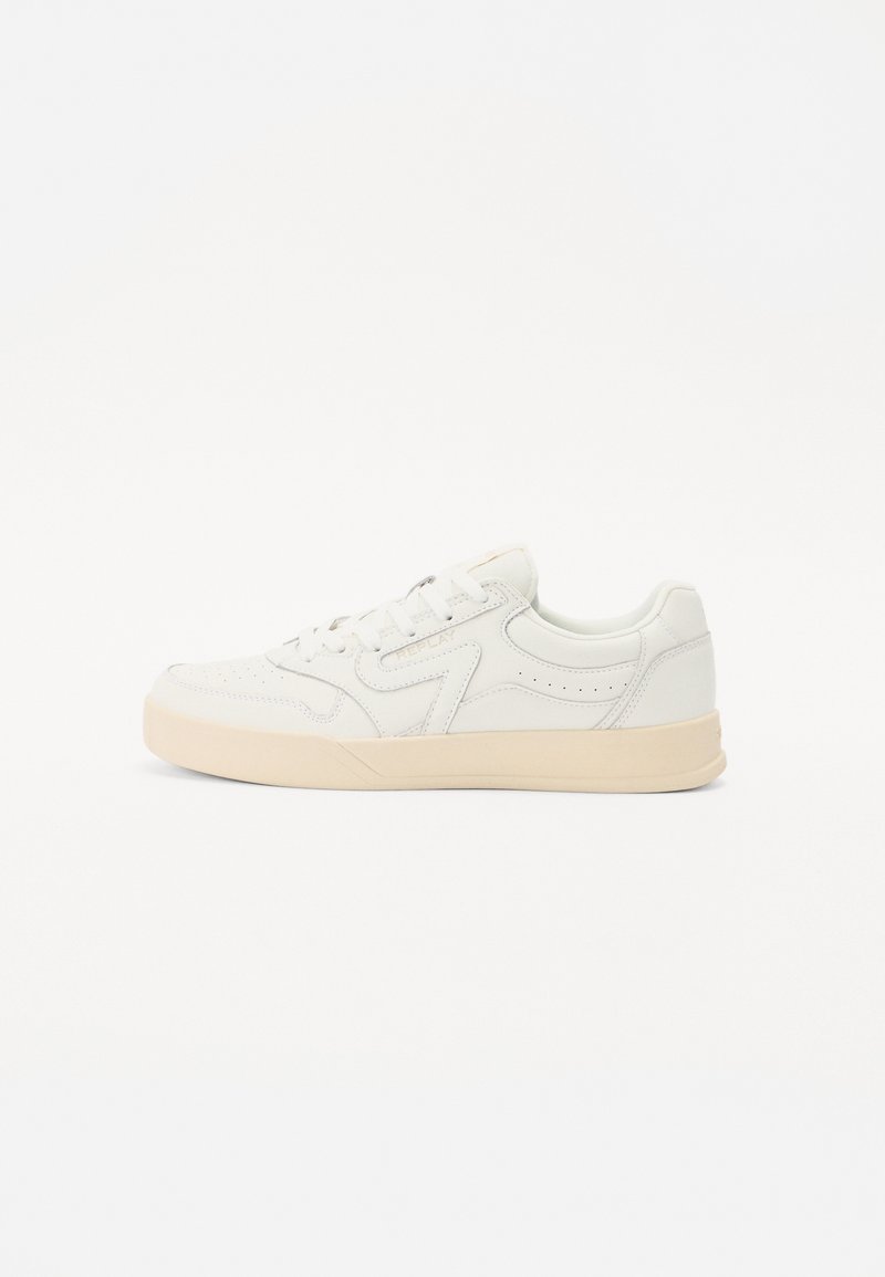 White leather sneaker with a low top design, textured toe cap, and subtle perforations on the sides. Light tan rubber sole.