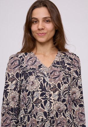 Floral-patterned dress featuring a V-neck, long sleeves, and button details. Colors include cream, navy, and blush with intricate designs.