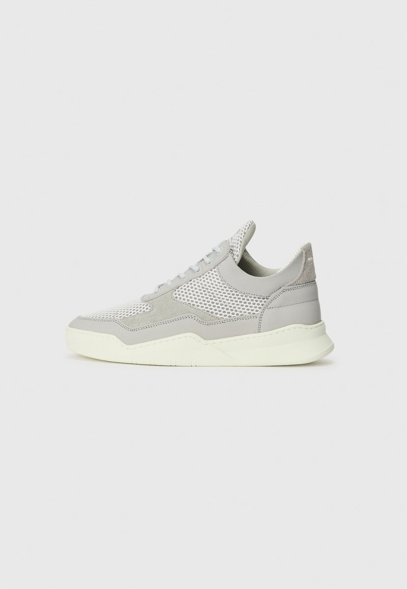 Gray sneaker with mesh and suede sections, rubber sole, and light-colored accents. Features curved design and textured panels.