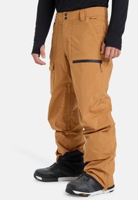 Braune wasserdichte Schneehosen mit Cargo-Taschen, gesichertem Bund und einer mit Reißverschluss versehenen Seitentasche; strukturiertes Material mit lockerer Passform.