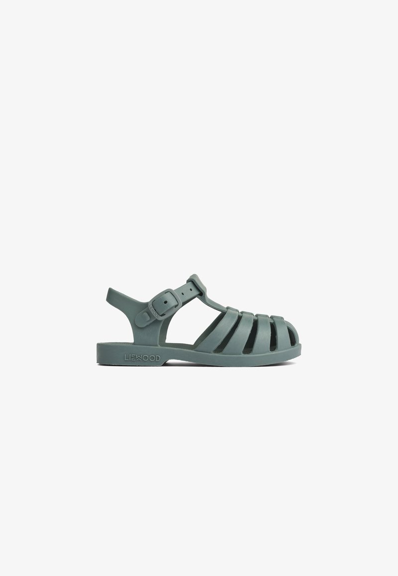 Roheline kummist sandaal, millel on rihmadega disain, reguleeritav pandla, avatud konts ja tekstuuriga pind. Märgistatud kaubamärgi nimega "LIEWOOD."
