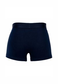 Boxers de algodón azul marino con una cinturilla suave, que presentan un diseño limpio y sin costuras y una pequeña abertura en la parte posterior.
