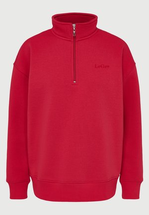 Red fleece pullover with high collar and half-zip closure. Ribbed cuffs and hem, featuring subtle "Le Ger" embossed logo on front.