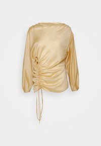 Pitkähihainen paita pehmeää keltaista satiinia, jossa on kootun sivun yksityiskohta ja koristet napit hartioilla.