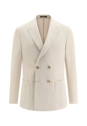 Beige dubbelgeknoopt colbert met brede revers, vier knopen van schildpadmotief, twee opgestikte zakken en één borstzak, weergegeven op een witte achtergrond.