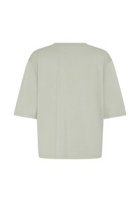 Maglietta gris chiaro oversize a maniche corte con scollo tondo, mostrata da dietro su sfondo bianco.