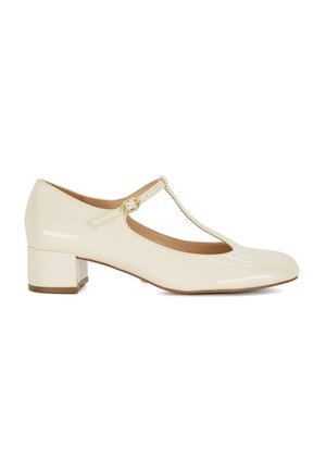 Beige lakleren Mary Jane-schoenen met een T-band, ronde neus en een lage blokhak. Kenmerkend is een goudkleurige gesp.