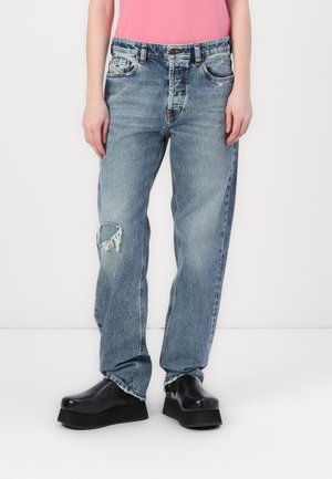 Light blue denim jeans with a relaxed fit, featuring a distressed knee, five-pocket design, and a slight fade. Paired with black platform shoes.
