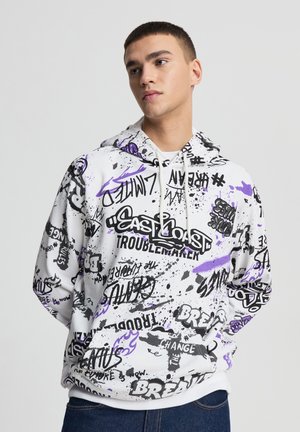 Felpa con cappuccio bianca con scritte e motivi in stile graffiti nero e viola. Presenta un cappuccio con coulisse e orlo a coste.
