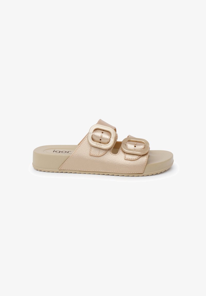 Sandale à glissière beige clair avec une tige en synthétique texturé, deux sangles réglables à boucle, et une semelle en caoutchouc rembourrée.