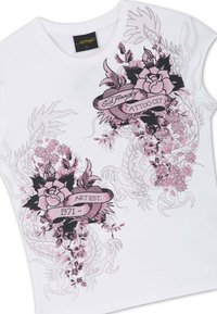 White short-sleeve shirt with pink and black floral tattoo-style designs and text reading "Ed Hardy Tattoo City" and "Art Est. 1971".