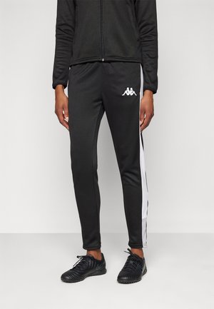Black athletic pants with white side stripes, featuring a logo on the upper leg. Made of smooth, lightweight material.