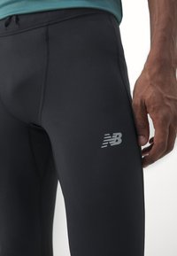 New Balance SLEEK REFLECIVE TIGHT - Leggings - black