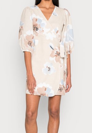 Floral wrap dress in beige with blue and peach patterns. Features puff sleeves, a V-neck, and textured fabric. Short length with a side tie.