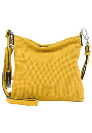 Sac bandoulière en cuir jaune perforé avec sangle réglable, fermoir métallique et étiquette portant la mention "SURI FREY."