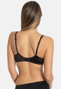 Black lace-back bra with adjustable straps, smooth texture, hook-and-eye closure, and minimalistic design.