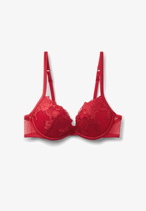 Czerwona bielizna z koronkowymi detalami w kwiaty, z głębokim dekoltem i regulowanymi ramiączkami. Posiada siateczkowe panele boczne oraz gładki pas z tyłu.