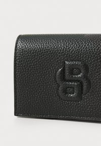Black textured leather wallet with embossed logo detail. Rectangular shape features a smooth edge and clean stitching accents.