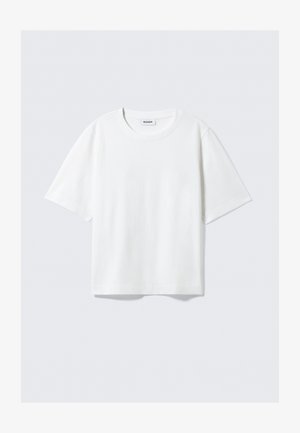 Vit kortärmad t-shirt i mjuk bomull, med rund halsringning och avslappnad passform med rak fåll, enfärgad utan mönster eller grafik.