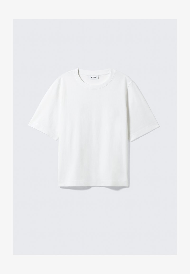 T-shirt blanc à manches courtes en coton doux, avec un col rond et une coupe décontractée à ourlet droit, uni sans motifs ni graphiques.
