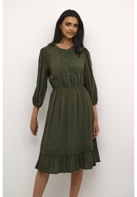 Olive green dress with three-quarter sleeves, featuring a button placket and lace trim details. Flared skirt with ruffled hem. Soft fabric.
