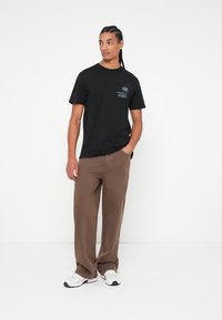 Rip Curl SPORTLINE TUBULAR TEE UNISEX - Tričko s potlačou - black