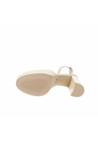 Sandal con tacco alto beige con finitura liscia, dotata di suola texturizzata e cinturino alla caviglia con fibbia in metallo.
