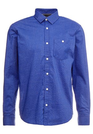 Chemise à manches longues à carreaux bleu et blanc avec un col boutonné, une poche poitrine simple et des boutons blancs. Tissu en coton, design décontracté.