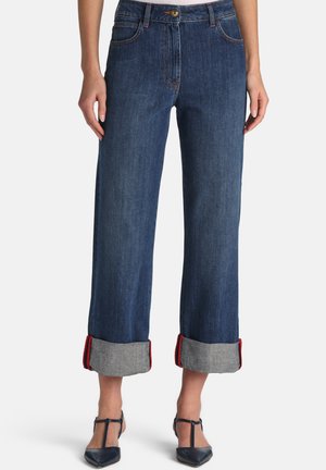 Dark denim wide-leg jeans with rolled cuffs, featuring contrasting gray fabric and red stitching accents. Metal button closure at waist.