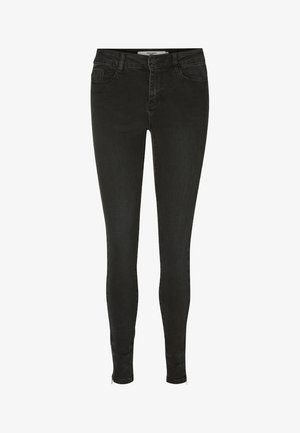 Jeans ajustados negros de mezclilla con una textura suave, que cuentan con cremallera, cuatro bolsillos y un diseño ceñido.