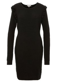 Svart ribbad stickad klänning med långa ärmar, volanger på axlarna, rund halsringning, smal passform och lätt böjning vid fållen.