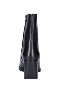 Black leather ankle boot with block heel and side zipper viewed from the back on a white background.
