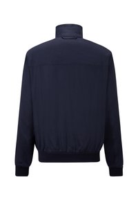 Veste bleu marine avec col montant, poignets élastiques et taille élastique. Tissu lisse et léger avec un design épuré et minimaliste.