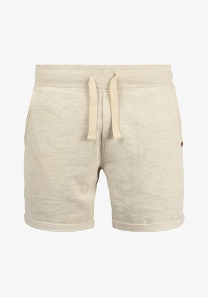 Lys beige treningsshorts laget av myk stoff. Har elastisk midje med snor og rullede ermer. Enkelt design uten mønstre.