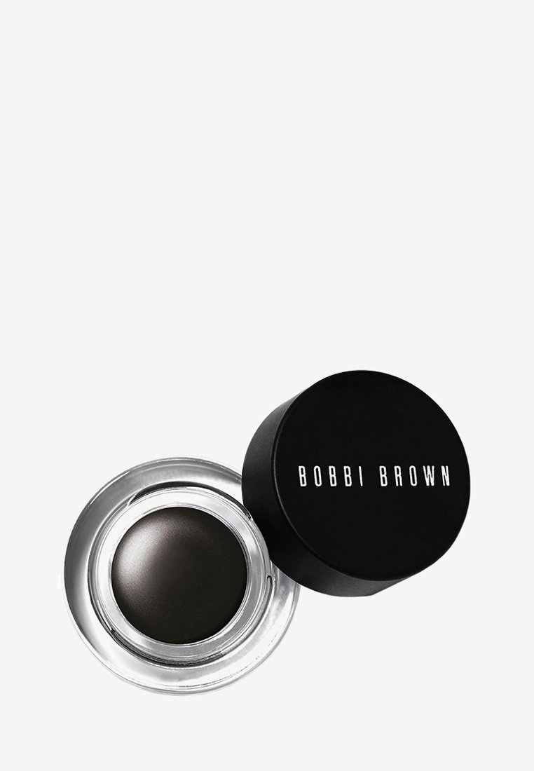 Bobbi Brown gel eyeliner i en klar glasbehållare med ett svart lock. Färgen är mörkgrå. Slät textur, rund form, minimalistisk design.