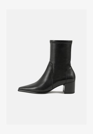 Black ankle boot made of smooth leather, featuring a pointed toe, a block heel, and distinct raised stitching at the top edge.