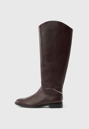 Dark brown knee-high leather boot with a flat heel and a small silver decorative charm near the ankle on a white background.