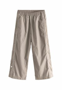 Pantalons crop beige clair avec ceinture élastique et ouvertures latérales à boutons-pression. Fabriqués en tissu doux et léger avec une texture lisse.