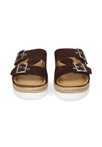 Brown suede sandals with two adjustable metallic buckles, a natural jute-wrapped platform sole, and a white rubber base.