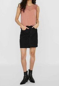 Sleeveless dusty rose top with lace detailing, paired with a black denim button-front skirt. Black ankle boots complete the outfit.