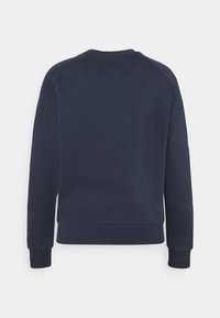Sweat-shirt bleu foncé à manches longues vu de dos avec poignets et ourlet côtelés sur un fond clair uni.