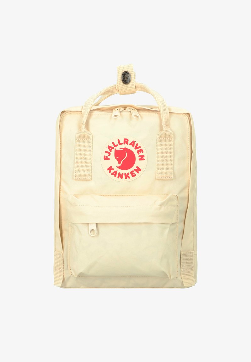 Sac à dos Fjällräven Kanken beige avec une grande poche frontale, une poignée supérieure robuste et un logo circulaire rouge avec un dessin de renard.