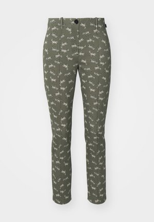 Slim-fit trousers in olive green fabric featuring a repeated zebra pattern. Standard waistband with a front button and pockets.