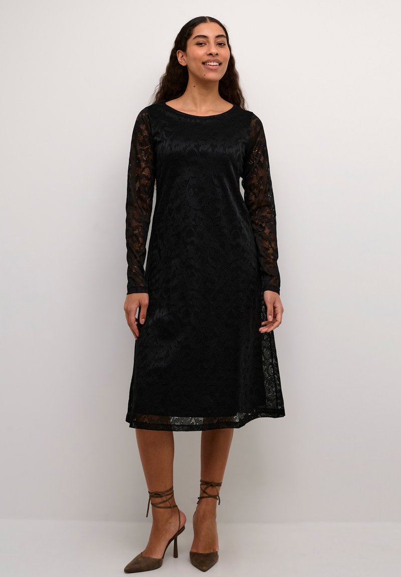 Black lace dress with long, sheer sleeves, round neckline, intricate floral pattern, mid-length, and a slightly flared silhouette.