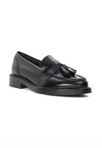 Black leather loafers with a rounded toe, featuring a front tassel detail and a low, stacked heel. Smooth texture with minimal stitching.