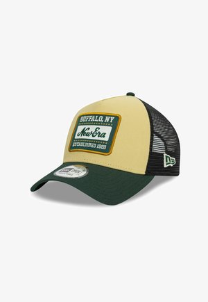 Trucker cap featuring a beige front panel, green visor, and black mesh back. Front patch displays "Buffalo, NY" and "New Era."